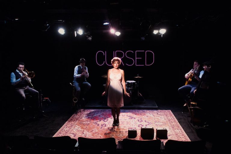 Cursed - the full band on stage: trombone, clarinet, drums, guitar and upright bass under the Cursed neon. HERE Arts Center, New York 2024. Photo: David Goddard